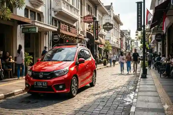 Sewa mobil lepas kunci Honda Brio RS merah di Jalan Braga Bandung, pilihan city car stylish dan irit.